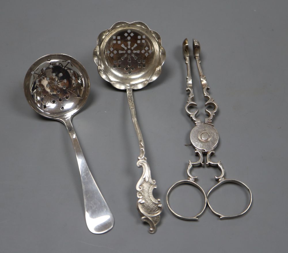 A pair of Georgian silver sugar nips(repair), 12cm and two silver sugar sifter spoons, gross 64 grams.